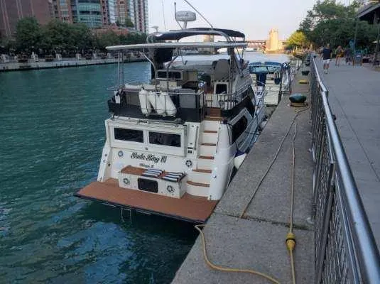 Slide: The Image of 1991 Cruisers Yachts 3850 Aft Cabin docked by the riverside. - 9