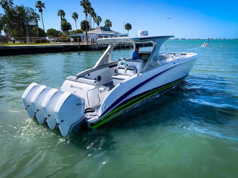 Slide: The Image of 2020 Mystic Powerboats M4200 cruising on clear blue water. - 62