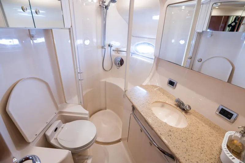 Slide: The Image of 2003 Sea Ray Express Bridge bathroom with shower, sink, and toilet in compact, elegant design. - 11