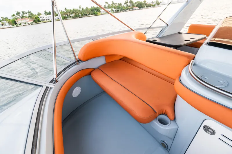 Slide: The Image of 2003 Sea Ray Express Bridge with orange seating, sleek design, and waterfront view. - 14