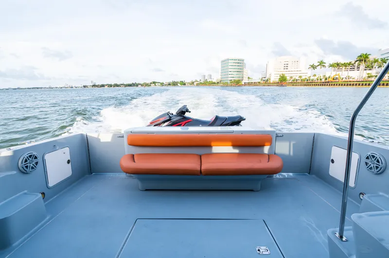 Slide: The Image of 2003 Sea Ray Express Bridge boat with orange seating, cruising on a sunny day. - 3