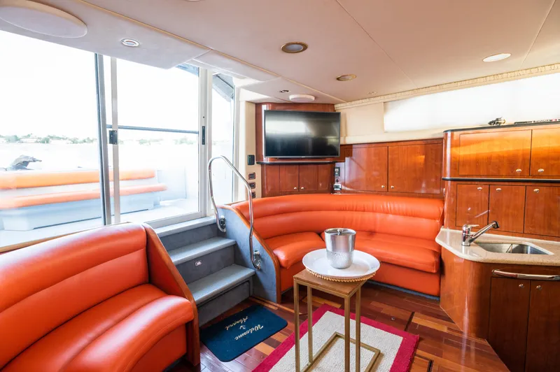 Slide: The Image of Luxurious 2003 Sea Ray Express Bridge interior with orange seating and modern amenities. - 6