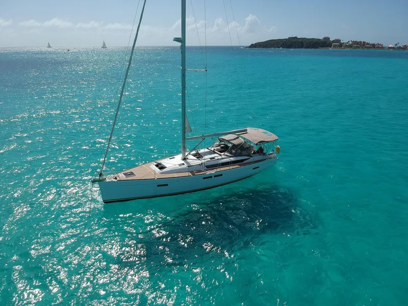 The Image of 2015 Jeanneau Sun Odyssey 469 sailing in clear turquoise waters. - 0