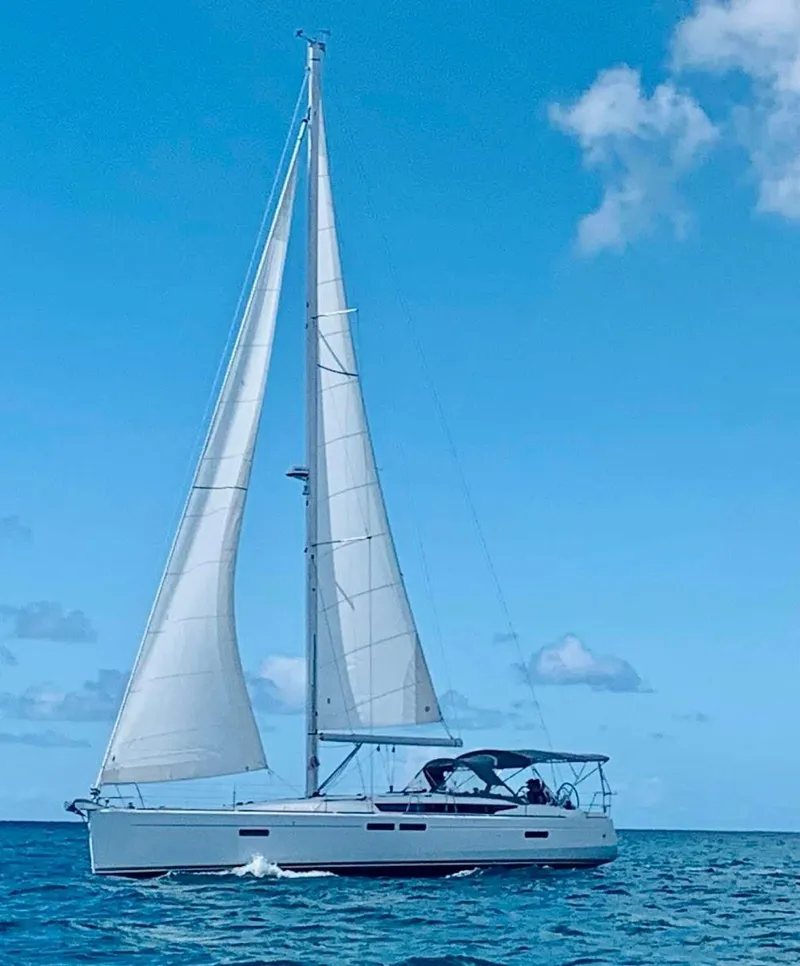 Slide: The Image of 2015 Jeanneau Sun Odyssey 469 sailing on open sea under clear blue sky. - 11