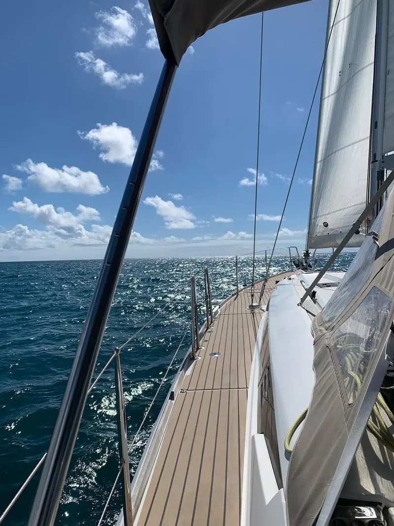 Slide: The Image of 2015 Jeanneau Sun Odyssey 469 sailing on open sea under clear blue sky. - 16