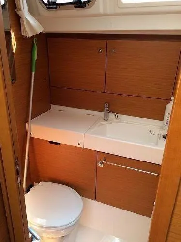 Slide: The Image of 2015 Jeanneau Sun Odyssey 469 bathroom with wooden cabinetry and compact sink. - 22