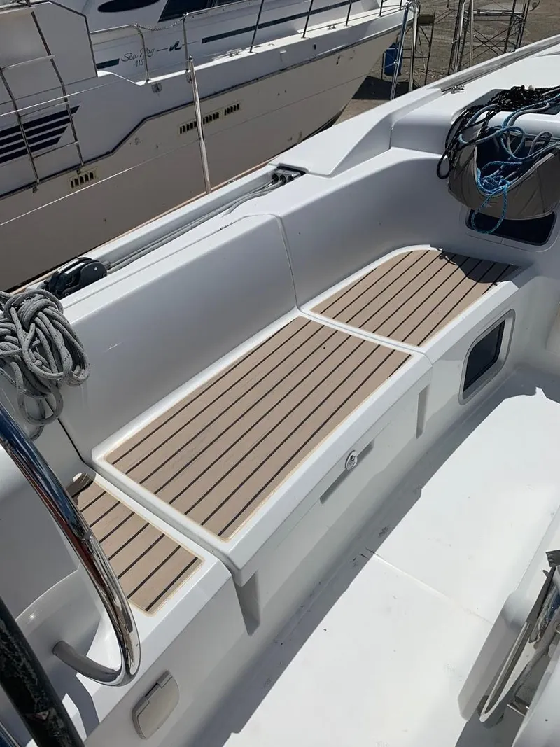 Slide: The Image of 2015 Jeanneau Sun Odyssey 469 cockpit with wooden seating and nautical ropes. - 26