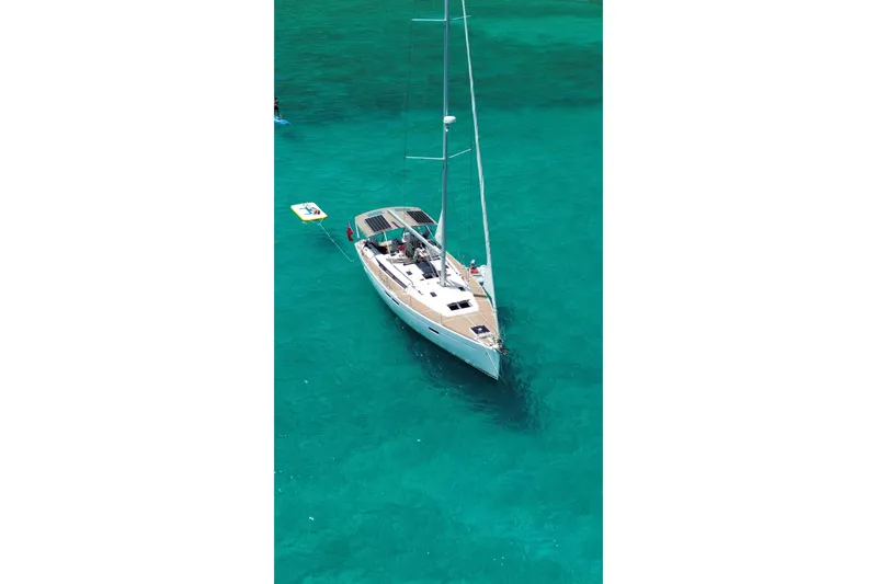 Slide: The Image of 2015 Jeanneau Sun Odyssey 469 sailboat on clear turquoise water. - 3