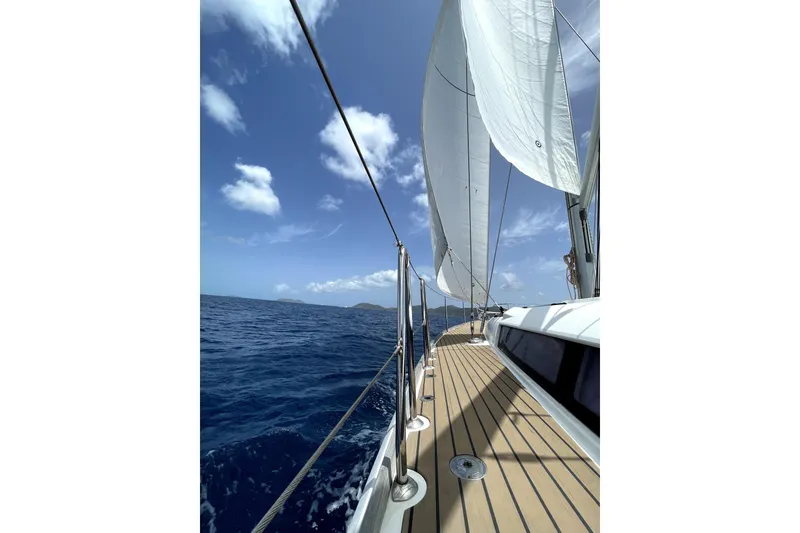 Slide: The Image of Sailing on a 2015 Jeanneau Sun Odyssey 469 yacht under clear blue skies. - 32