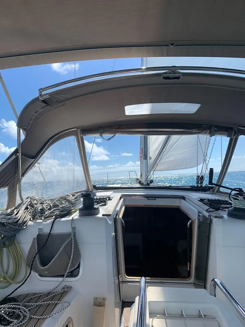 Slide: The Image of 2015 Jeanneau Sun Odyssey 469 sailing on open water under clear blue skies. - 33