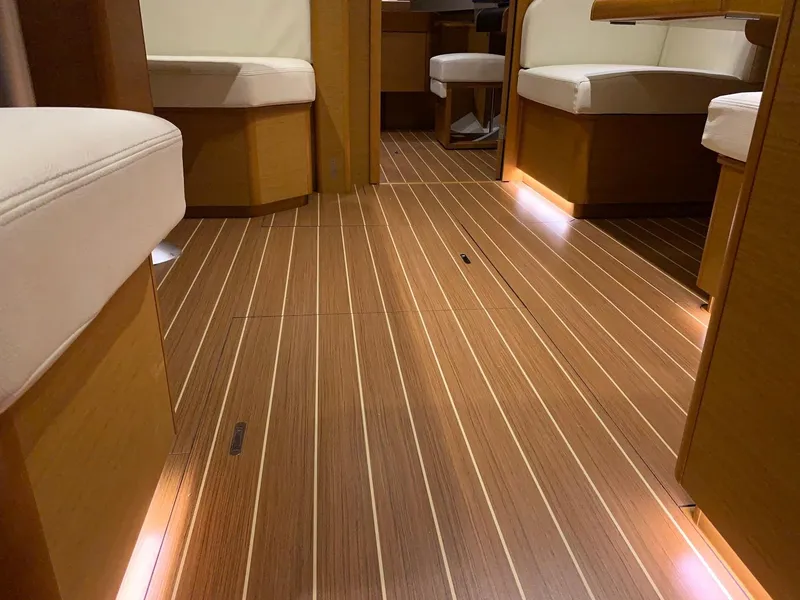 Slide: The Image of Interior of 2015 Jeanneau Sun Odyssey 469 yacht with wooden flooring and cushioned seating. - 38