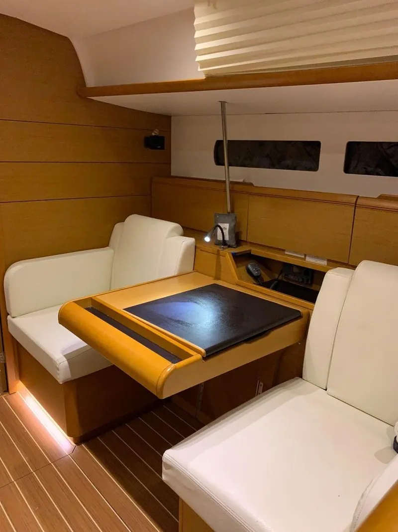 Slide: The Image of Interior of 2015 Jeanneau Sun Odyssey 469 yacht with elegant seating and wooden table. - 41