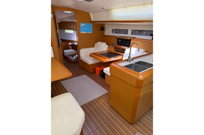 Slide: The Image of Interior of 2015 Jeanneau Sun Odyssey 469 yacht, featuring modern kitchen and seating area. - 48