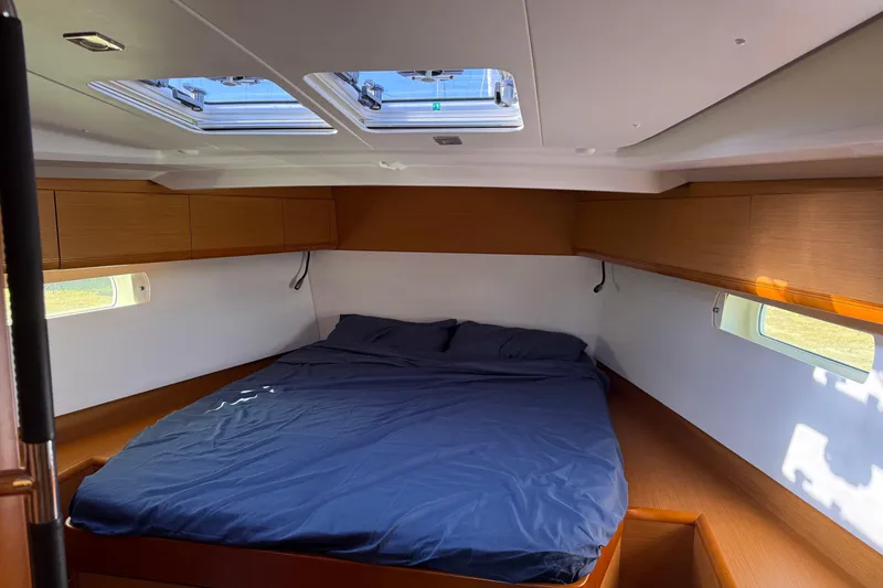 Slide: The Image of Cozy cabin interior of 2015 Jeanneau Sun Odyssey 469 sailboat with skylights and wooden accents. - 51