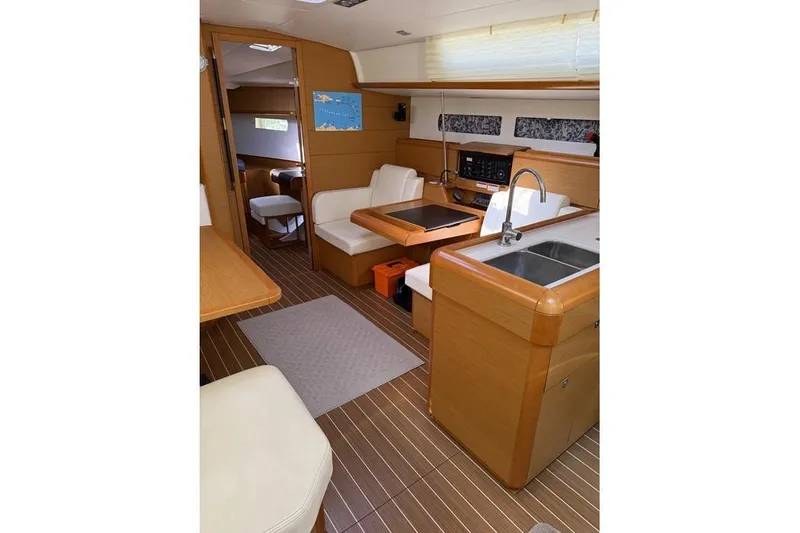 Slide: The Image of Interior of 2015 Jeanneau Sun Odyssey 469 yacht with modern kitchen and seating area. - 52