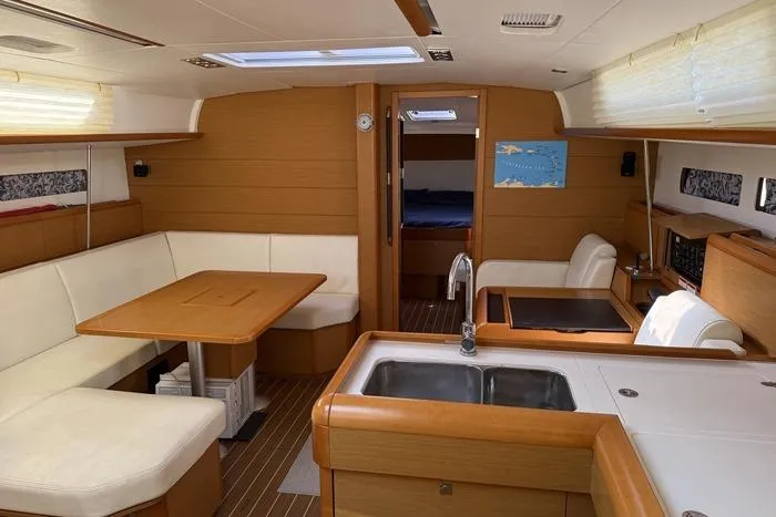 Slide: The Image of Interior of 2015 Jeanneau Sun Odyssey 469 yacht with modern kitchen and seating area. - 56