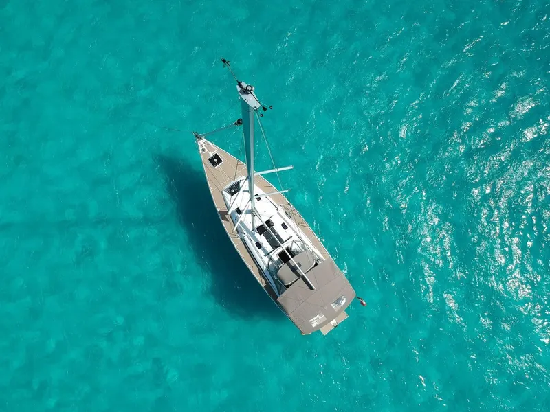Slide: The Image of Aerial view of 2015 Jeanneau Sun Odyssey 469 sailing on clear turquoise water. - 7