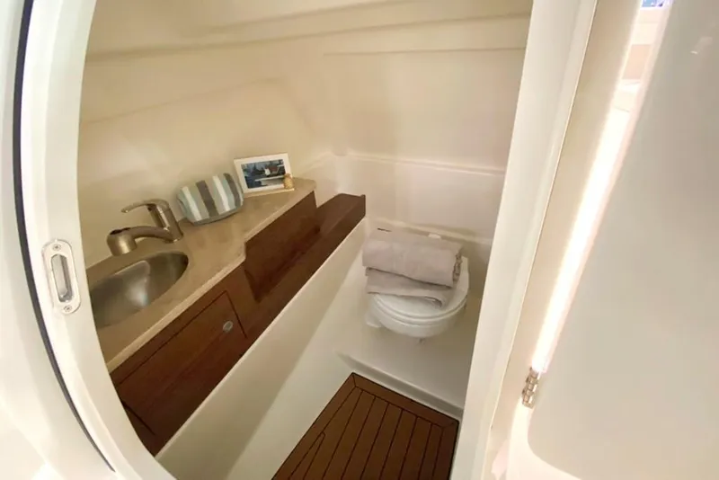 Slide: The Image of 2023 Boston Whaler 280 Vantage boat interior bathroom with sink and toilet. - 9