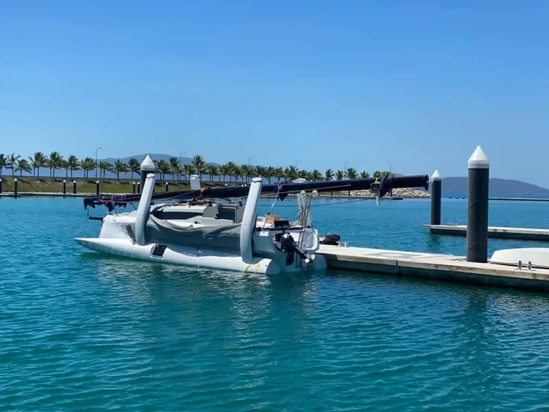 Slide: The Image of 2025 Corsair 880 trimaran docked in a sunny marina. - 13