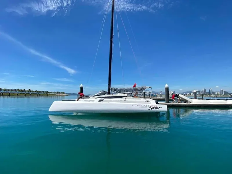 Slide: The Image of 2025 Corsair 880 sailboat docked in a marina under clear blue skies. - 15