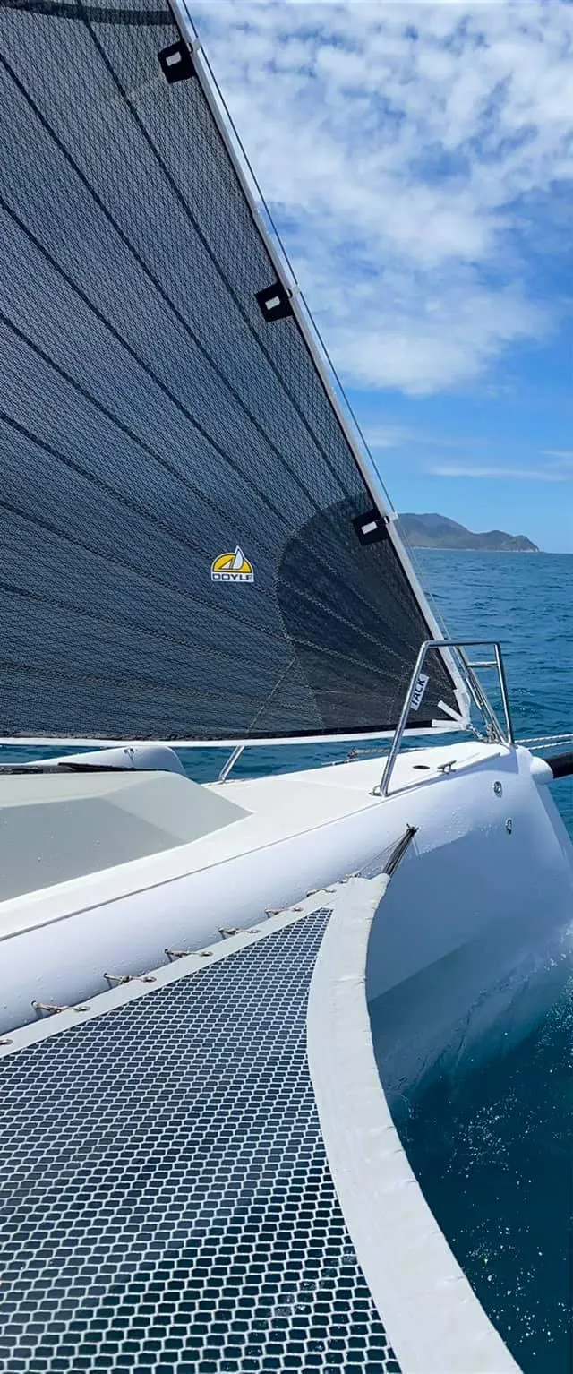 Slide: The Image of Sleek 2025 Corsair 880 sailboat gliding on blue ocean under clear sky. - 17