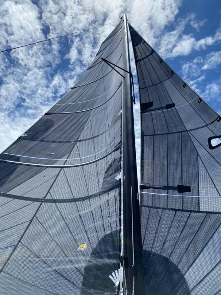 Slide: The Image of Sail of a 2025 Corsair 880 against a blue sky with clouds. - 18