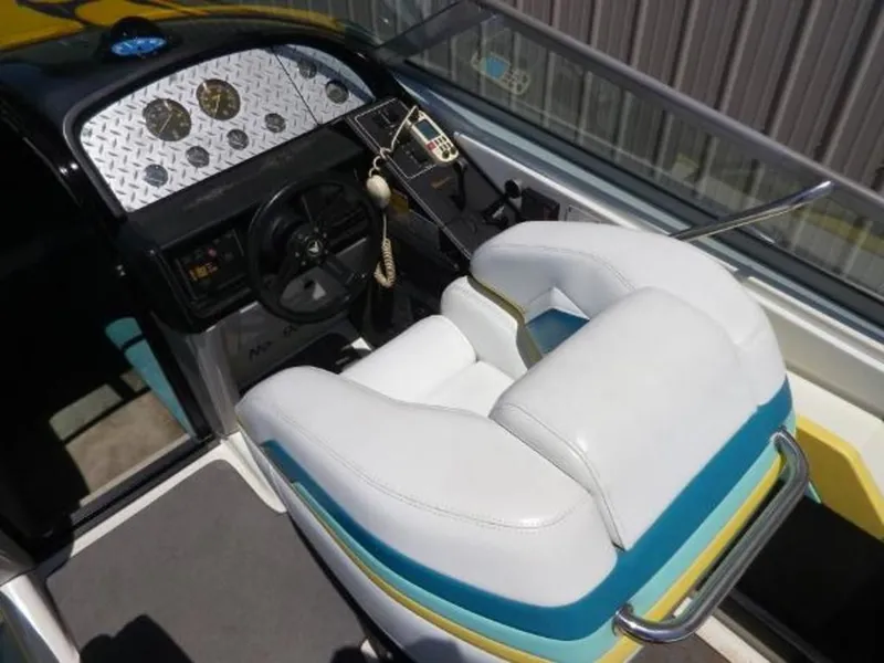 Slide: The Image of 1992 Formula Boats 27 cockpit with steering wheel, gauges, and white cushioned seat. - 10
