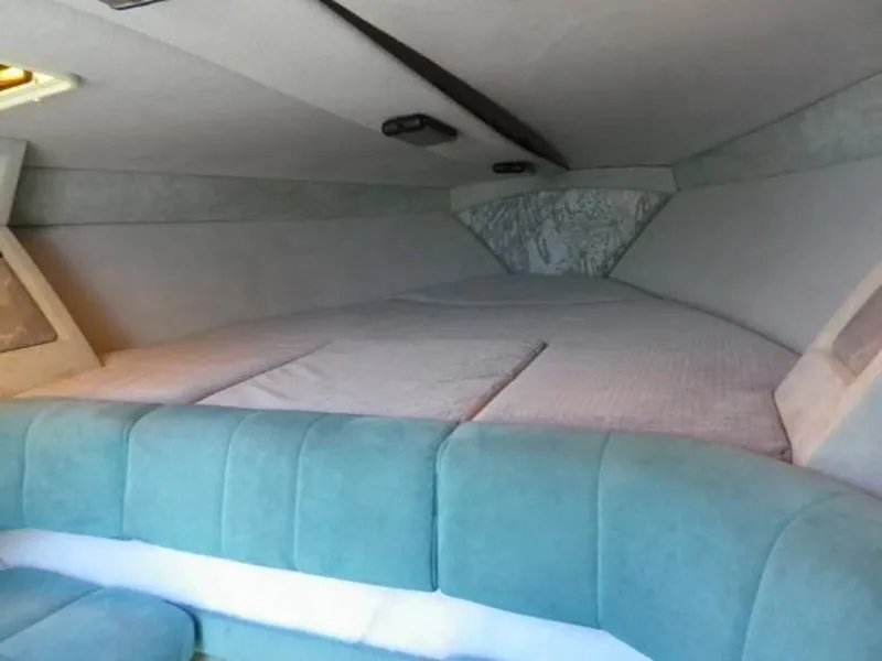 Slide: The Image of Interior cabin of 1992 Formula Boats 27 model with cushioned seating and sleeping area. - 12