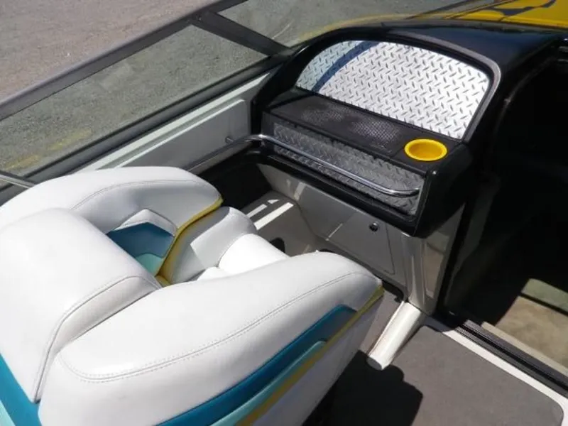 Slide: The Image of Interior of a 1992 Formula Boats 27, featuring white seating and a dashboard with a cup holder. - 13