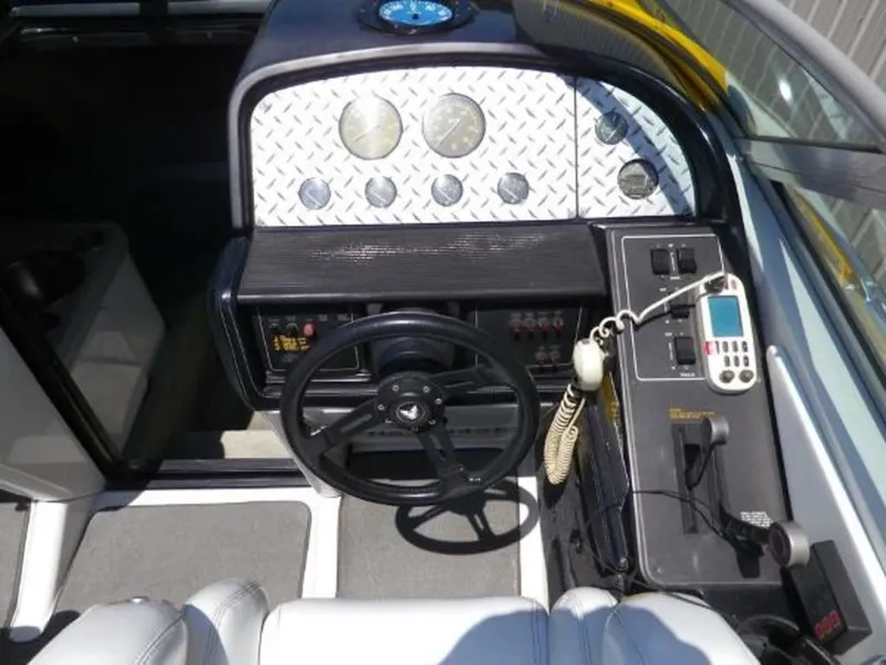 Slide: The Image of 1992 Formula Boats 27 cockpit with steering wheel, gauges, and communication equipment. - 15