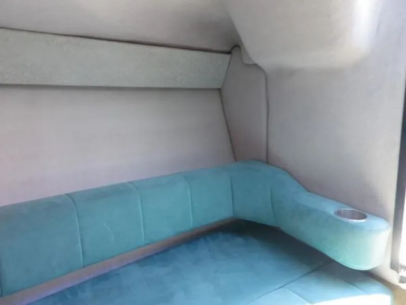 Slide: The Image of Interior cabin of 1992 Formula Boats 27 with teal seating and cup holder. - 16