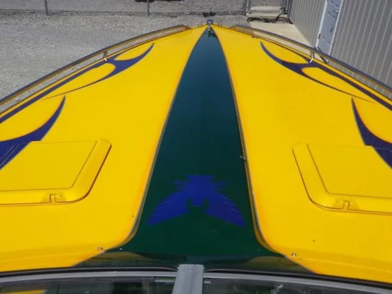 Slide: The Image of 1992 Formula Boats 27 with vibrant yellow and blue deck design. - 4