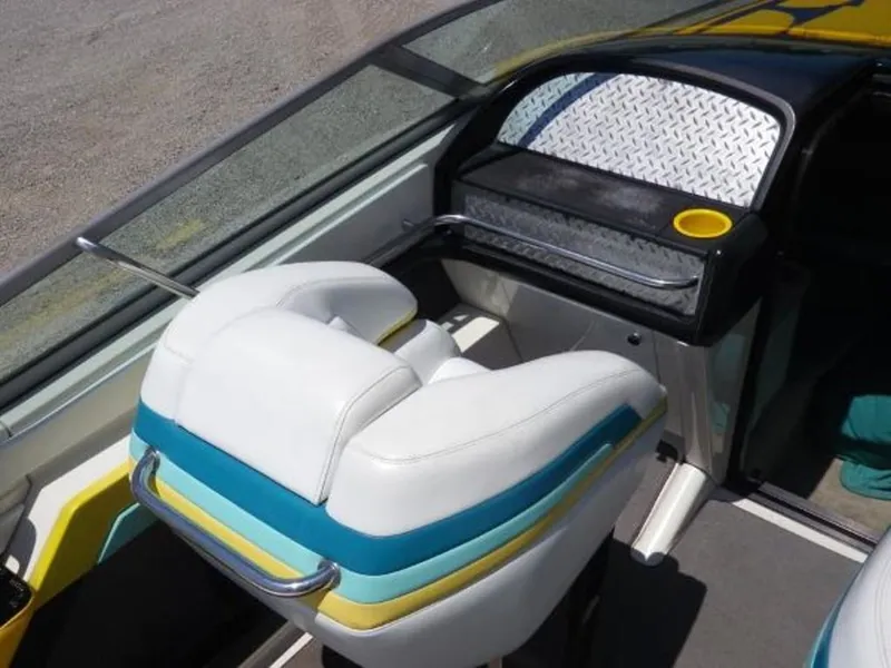 Slide: The Image of Interior of a 1992 Formula Boats 27, featuring white and teal seating. - 5