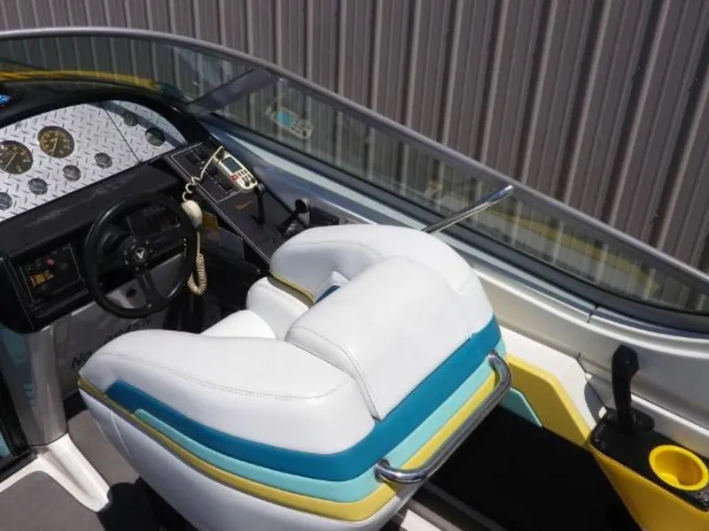 Slide: The Image of 1992 Formula Boats 27 cockpit with white and blue seating, steering wheel, and control panel. - 8
