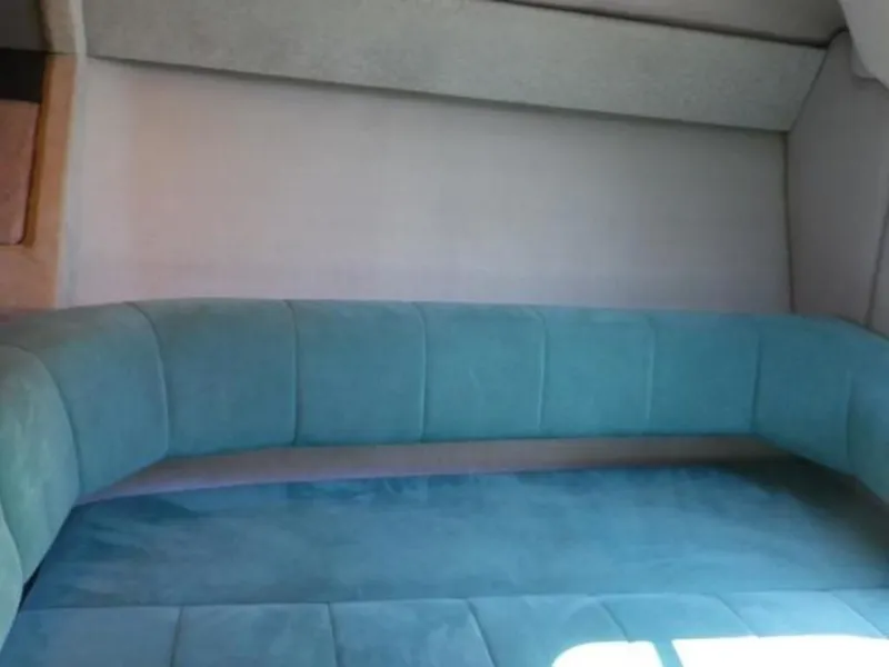 Slide: The Image of Interior seating area of a 1992 Formula Boats 27 model with teal upholstery. - 9