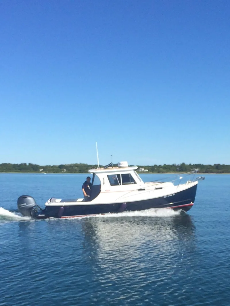 Slide: The Image of 2016 Eastern 248 Explorer boat cruising on calm blue water under clear sky. - 0