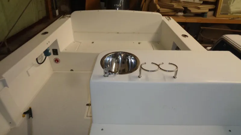 Slide: The Image of 2016 Eastern 248 Explorer boat interior with sink and cup holders. - 12