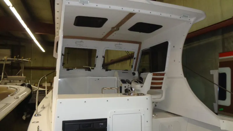 Slide: The Image of 2016 Eastern 248 Explorer boat interior with helm and seating. - 4