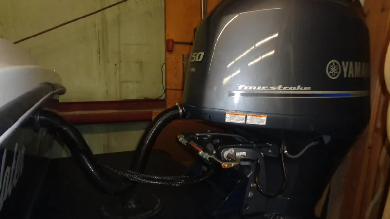 Slide: The Image of 2016 Eastern 248 Explorer with Yamaha 150 four-stroke outboard engine in a garage setting. - 5