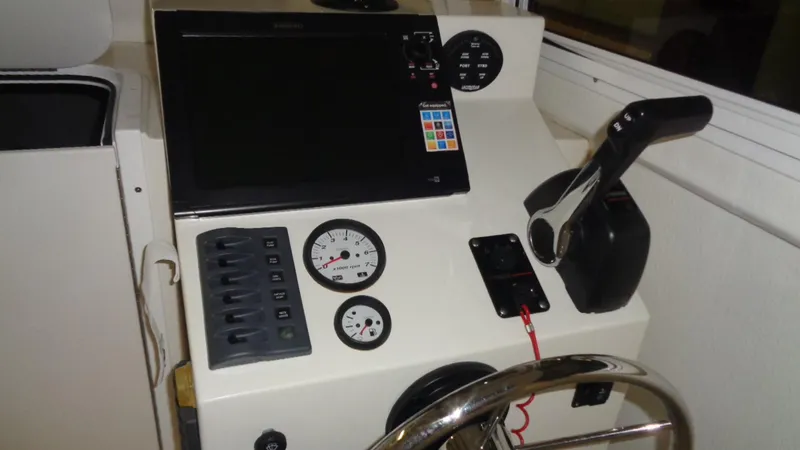 Slide: The Image of Control panel of a 2016 Eastern 248 Explorer boat with gauges and throttle. - 8