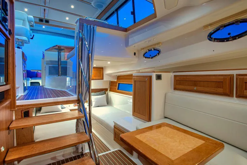 Slide: The Image of Luxurious interior of the 2025 Back Cove 39O yacht with modern furnishings and ambient lighting. - 13