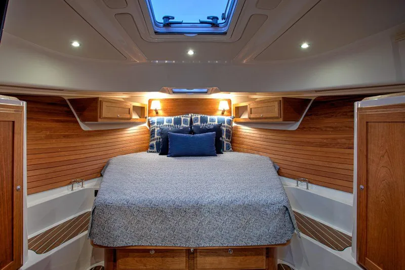 Slide: The Image of Luxurious cabin interior of 2025 Back Cove 39O yacht with cozy bed and wooden accents. - 14