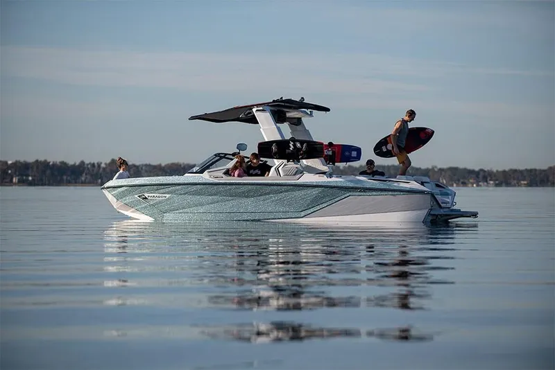 Slide: The Image of 2023 Nautique Super Air Nautique G25 Paragon on calm water with passengers. - 0