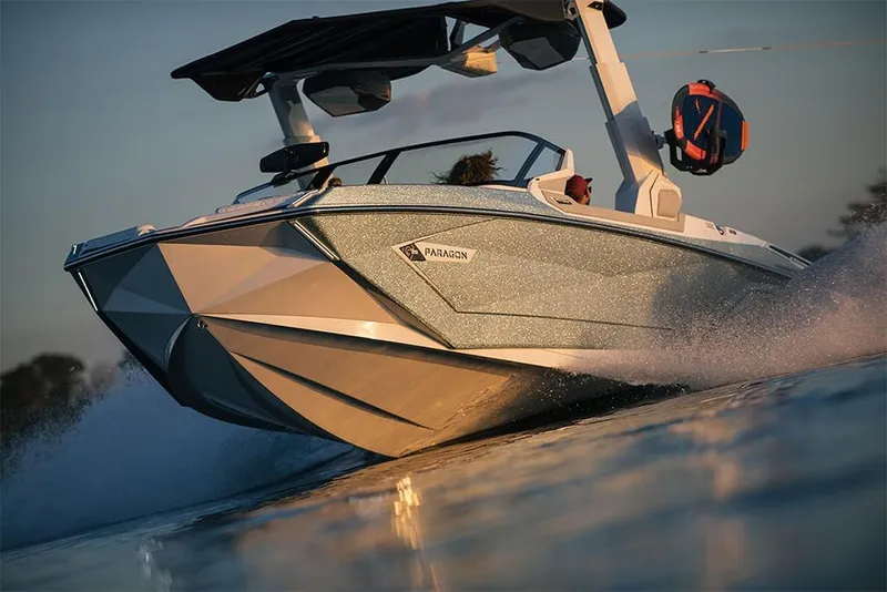 Slide: The Image of 2023 Nautique Super Air Nautique G25 Paragon speeding on water at sunset. - 13