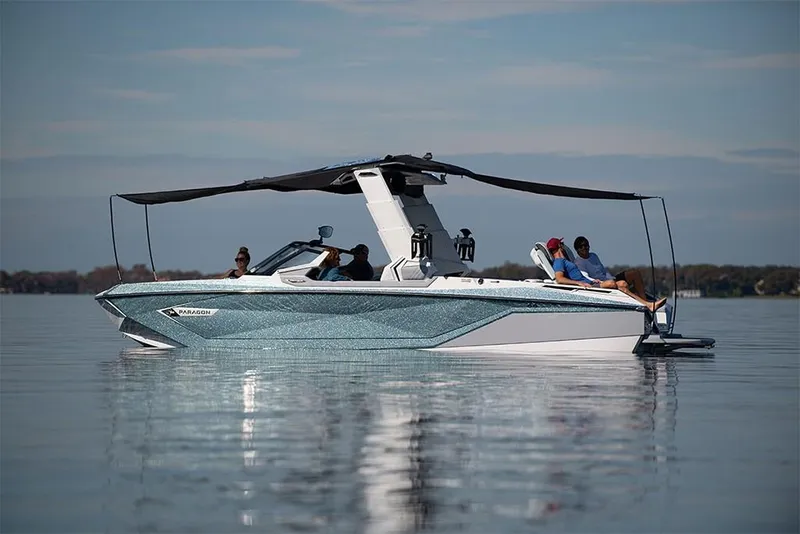 Slide: The Image of 2023 Nautique Super Air Nautique G25 Paragon on calm water with passengers. - 7