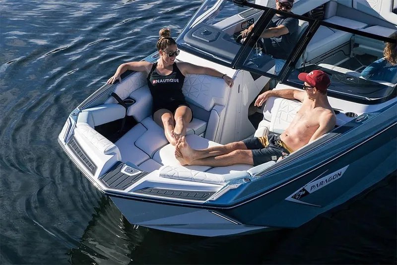 Slide: The Image of 2023 Nautique Super Air Nautique G25 Paragon with passengers relaxing on the bow. - 9