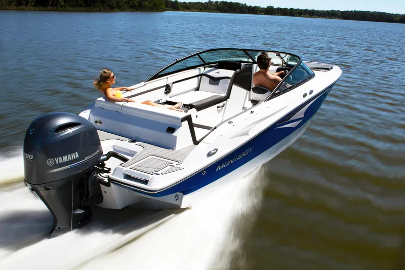 Slide: The Image of 2024 Monterey 235SS boat cruising on a lake with two passengers. - 5