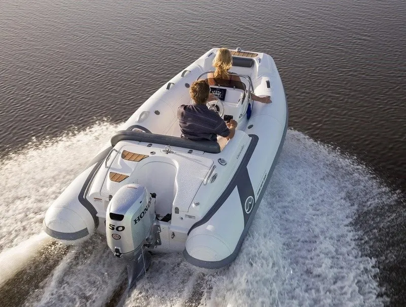 Slide: The Image of 2024 Walker Bay Generation 400 DLX boat cruising on water. - 5