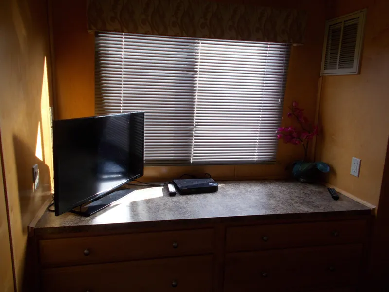 Slide: The Image of TV and decor on a dresser in American Waterways Sapphire Skies 1/10 Ownership, 2006 model. - 10