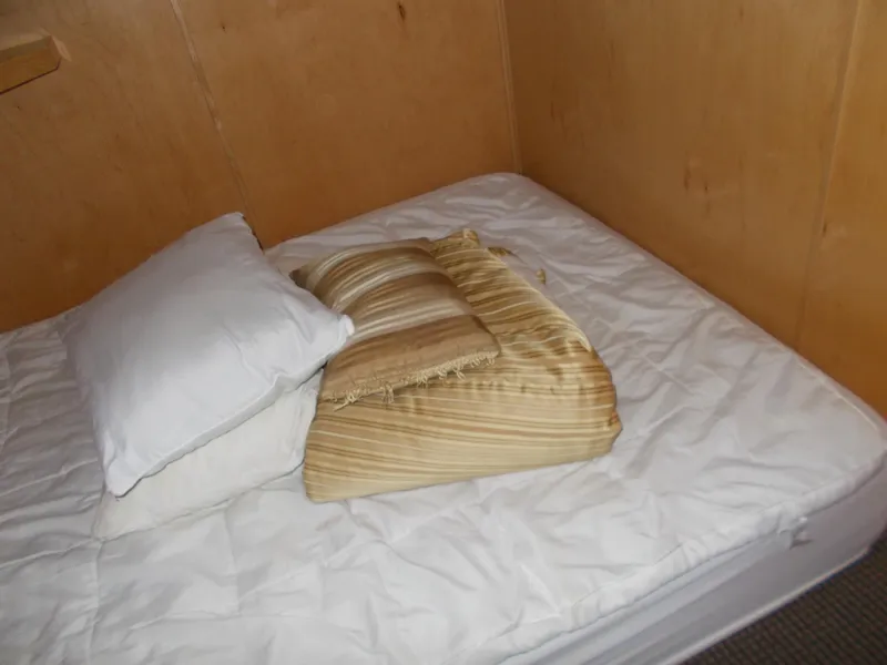 Slide: The Image of Small cabin bed with white bedding and striped pillow on American Waterways Sapphire Skies yacht, 2006 model. - 13